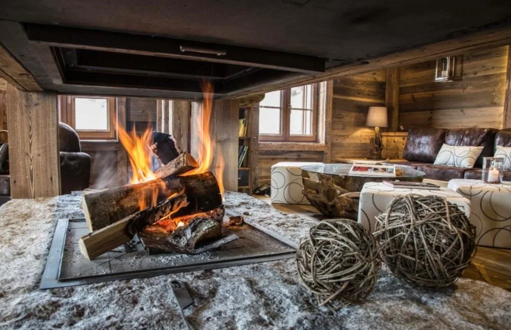 Cheminée centrale et salon du chalet Wood & Stone